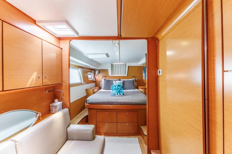 Azuria Yacht Photos Pics Luxurious interior of 2011 Lagoon 500 yacht with cozy bedroom and wooden cabinetry.