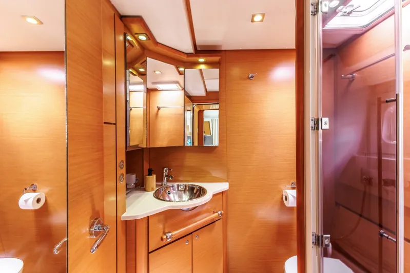 Azuria Yacht Photos Pics Luxurious bathroom interior of 2011 Lagoon 500 yacht with wood finish and modern fixtures.