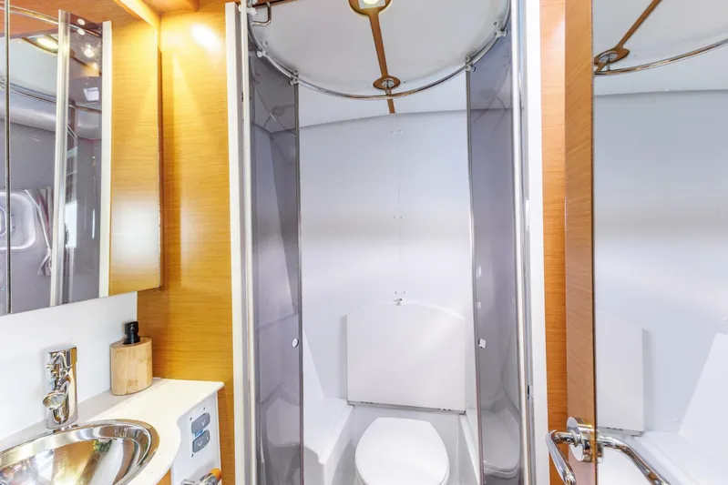 Azuria Yacht Photos Pics Luxurious bathroom in 2011 Lagoon 500 yacht with modern fixtures and wooden accents.