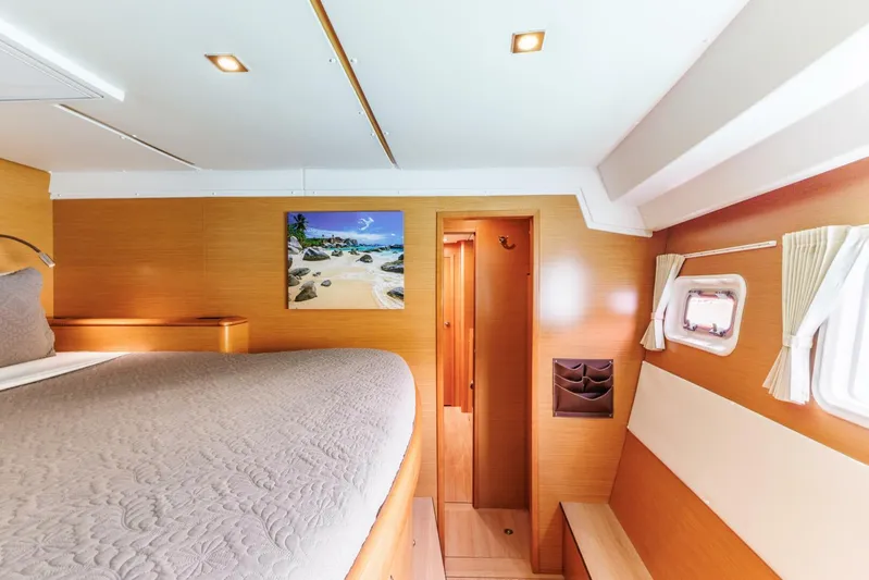 Azuria Yacht Photos Pics Luxurious cabin interior of a 2011 Lagoon 500 yacht with cozy bedding and scenic artwork.