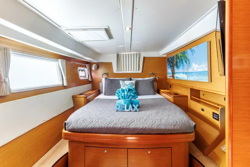 Azuria Yacht Photos Pics Luxurious cabin interior of 2011 Lagoon 500 yacht with cozy bed and scenic artwork.