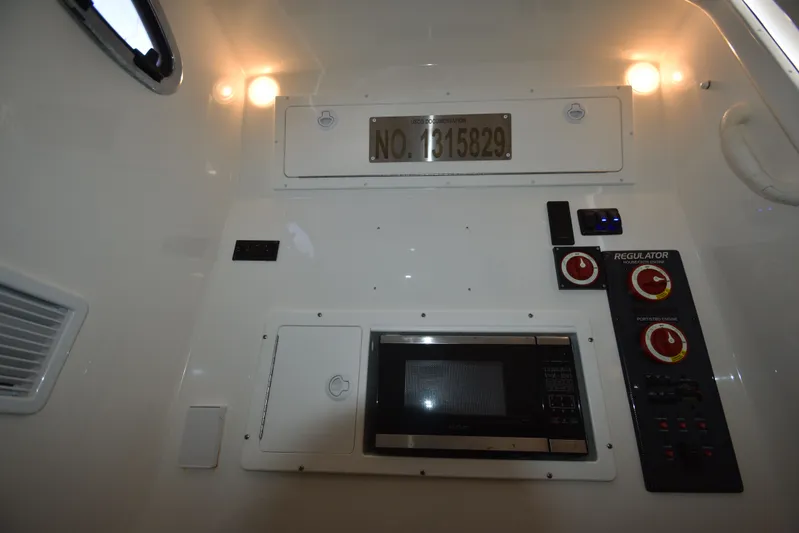 Why Knot II Yacht Photos Pics Interior of 2018 Regulator 34SS boat with controls and microwave.