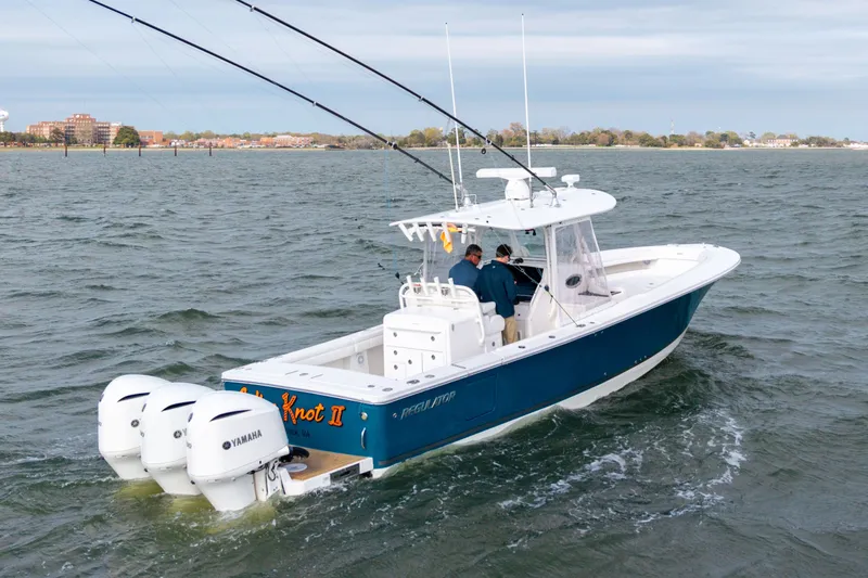 Why Knot II Yacht Photos Pics 2018 Regulator 34SS boat on water with two people aboard.