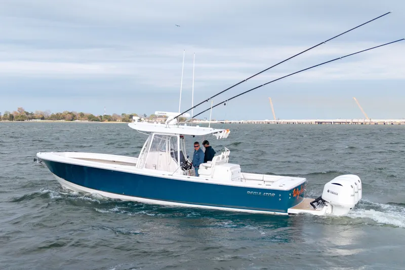 Why Knot II Yacht Photos Pics 2018 Regulator 34SS boat on water with dual outboard engines.