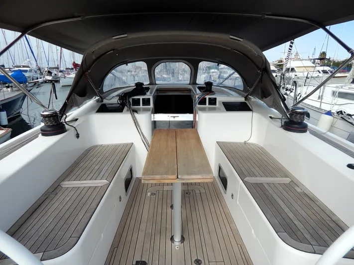  Yacht Photos Pics Italia Yachts 13.98 (2021) cockpit with wooden seating and table, docked at marina.