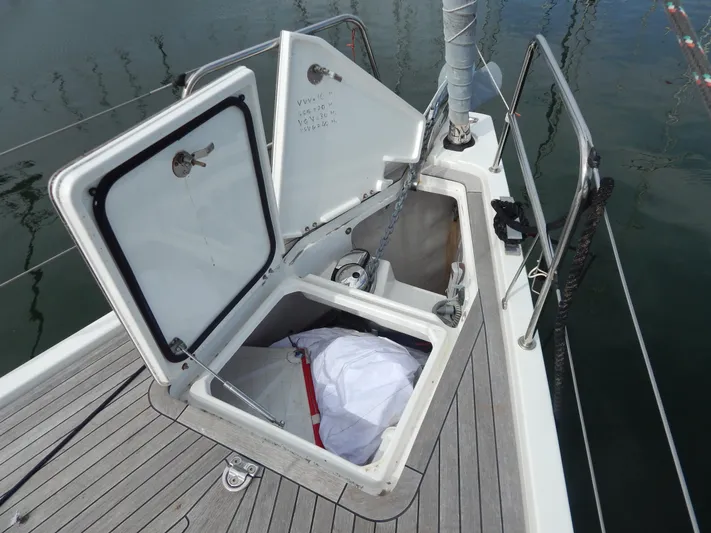  Yacht Photos Pics Italia Yachts 13.98 (2021) deck with open storage compartment and visible sail.