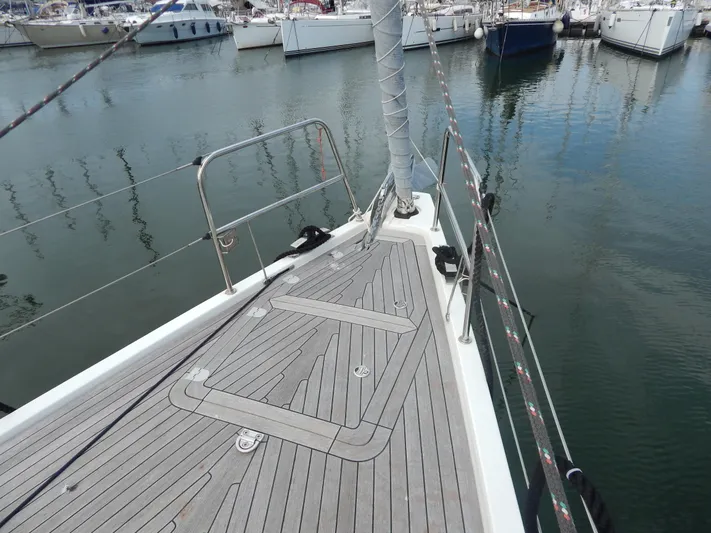  Yacht Photos Pics Italia Yachts 13.98 (2021) sailboat deck in marina, showcasing sleek design and craftsmanship.