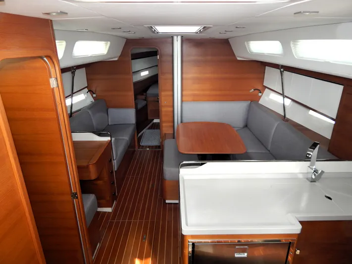  Yacht Photos Pics Luxurious interior of 2021 Italia Yachts 13.98, featuring elegant wood finishes and modern seating.
