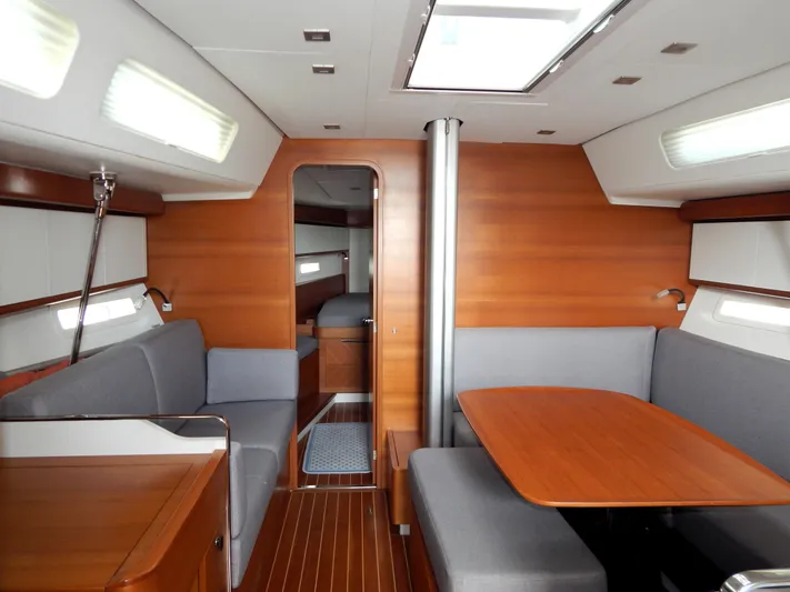  Yacht Photos Pics Luxurious interior of 2021 Italia Yachts 13.98, featuring elegant wood finishes and modern seating.