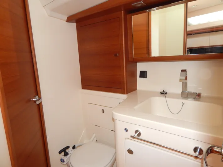  Yacht Photos Pics Italia Yachts 13.98 2021 bathroom with wooden cabinetry and modern fixtures.