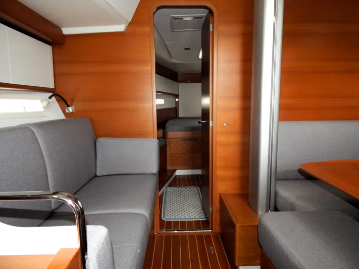  Yacht Photos Pics Interior of 2021 Italia Yachts 13.98, featuring elegant wood finish and gray seating.