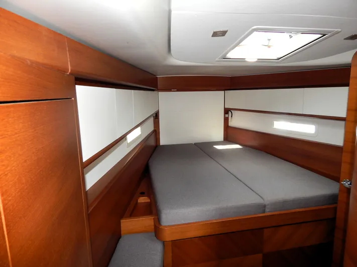  Yacht Photos Pics Italia Yachts 13.98 (2021) interior cabin with wooden finish and comfortable bedding.