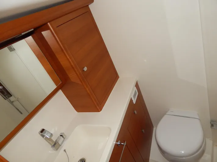  Yacht Photos Pics Italia Yachts 13.98 2021 bathroom with wooden cabinetry and modern fixtures.