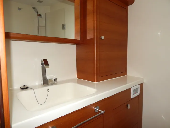  Yacht Photos Pics Italia Yachts 13.98 (2021) bathroom with wooden cabinetry and modern sink.