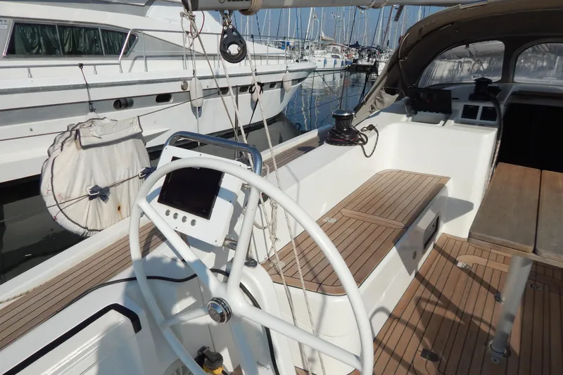  Yacht Photos Pics Italia Yachts 13.98 (2021) sailboat cockpit with wooden seating and steering wheel.