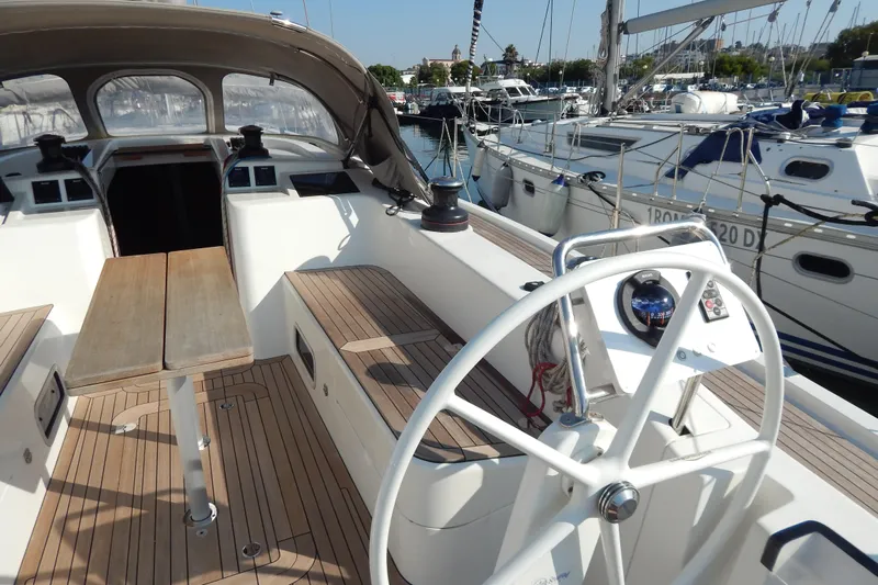  Yacht Photos Pics Italia Yachts 13.98 (2021) sailboat cockpit with wooden deck and steering wheel.