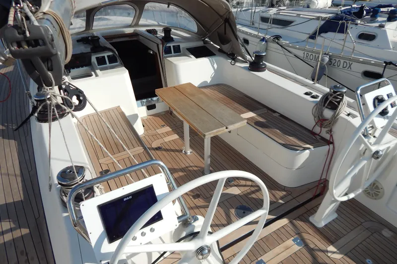  Yacht Photos Pics Italia Yachts 13.98 (2021) sailboat cockpit with dual steering wheels and wooden deck.