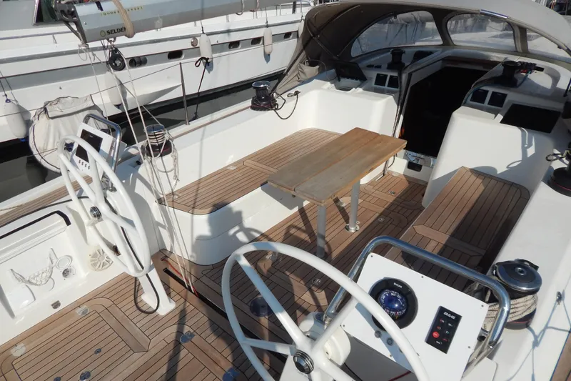  Yacht Photos Pics Italia Yachts 13.98 (2021) sailboat cockpit with dual steering wheels and teak flooring.