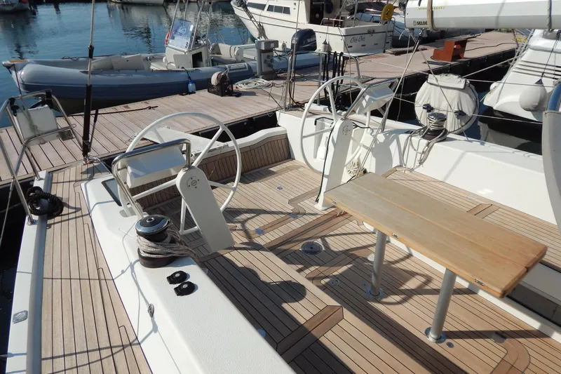  Yacht Photos Pics Italia Yachts 13.98 (2021) sailboat cockpit with dual steering wheels and wooden deck.