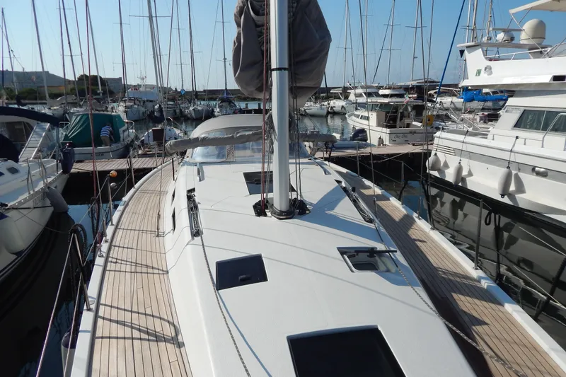  Yacht Photos Pics Italia Yachts 13.98 (2021) sailboat docked in a marina, surrounded by other boats.