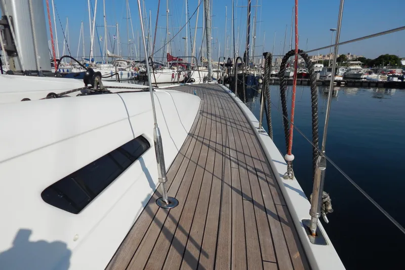  Yacht Photos Pics Italia Yachts 13.98 (2021) sailboat deck in marina, showcasing sleek design and craftsmanship.