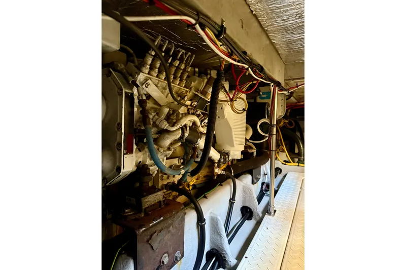 Trademarc Yacht Photos Pics Engine room of a 2004 Meridian 490 Pilothouse yacht, showcasing complex machinery and wiring.