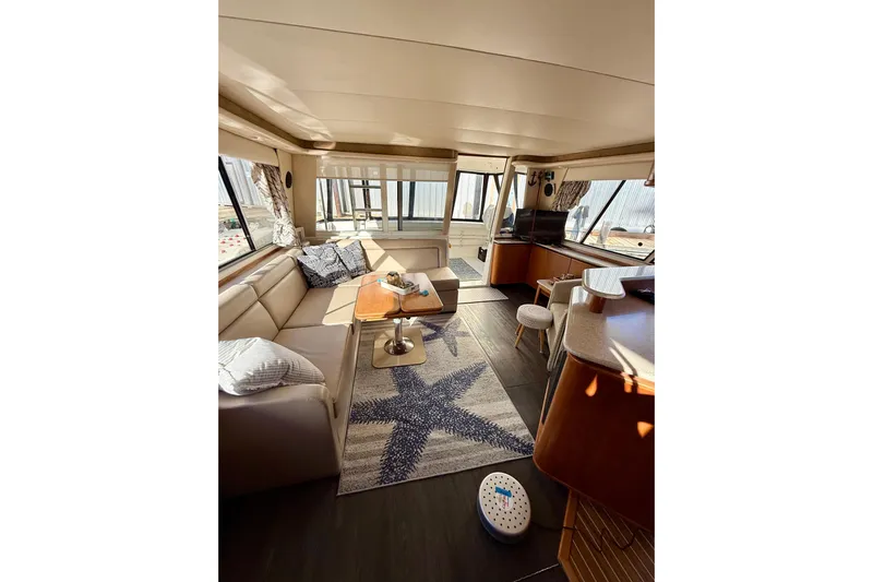Trademarc Yacht Photos Pics Luxurious interior of 2004 Meridian 490 Pilothouse yacht with cozy seating and modern decor.