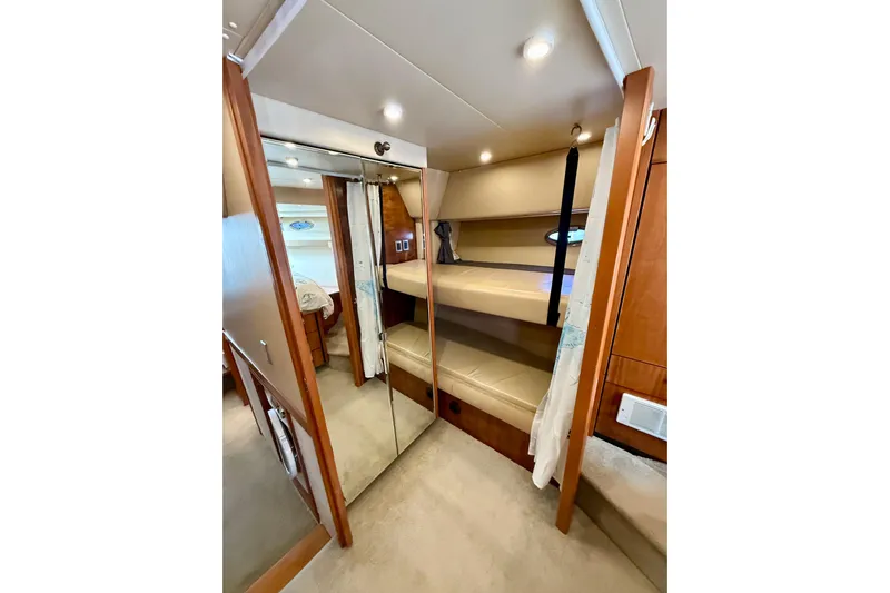Trademarc Yacht Photos Pics Interior of 2004 Meridian 490 Pilothouse yacht with bunk beds and mirrored closet.