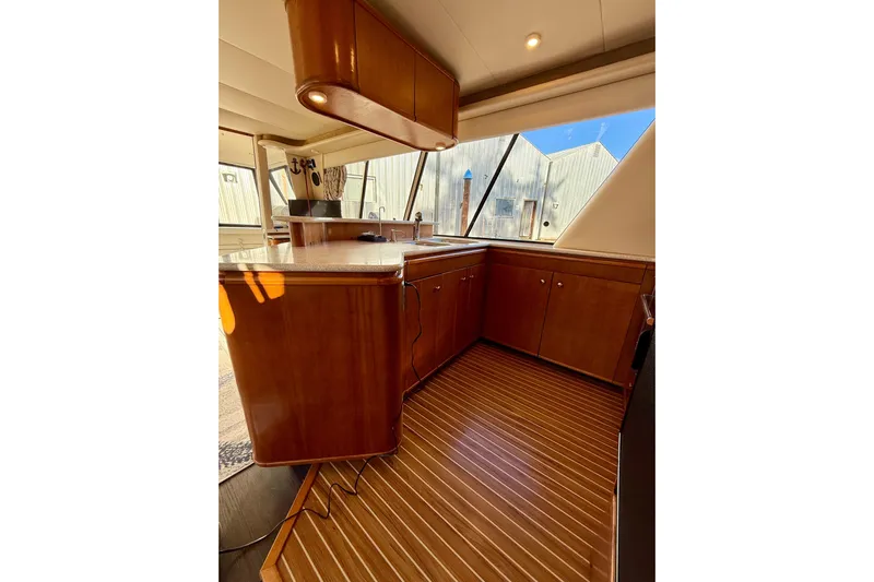 Trademarc Yacht Photos Pics Interior of 2004 Meridian 490 Pilothouse with wooden cabinetry and flooring.