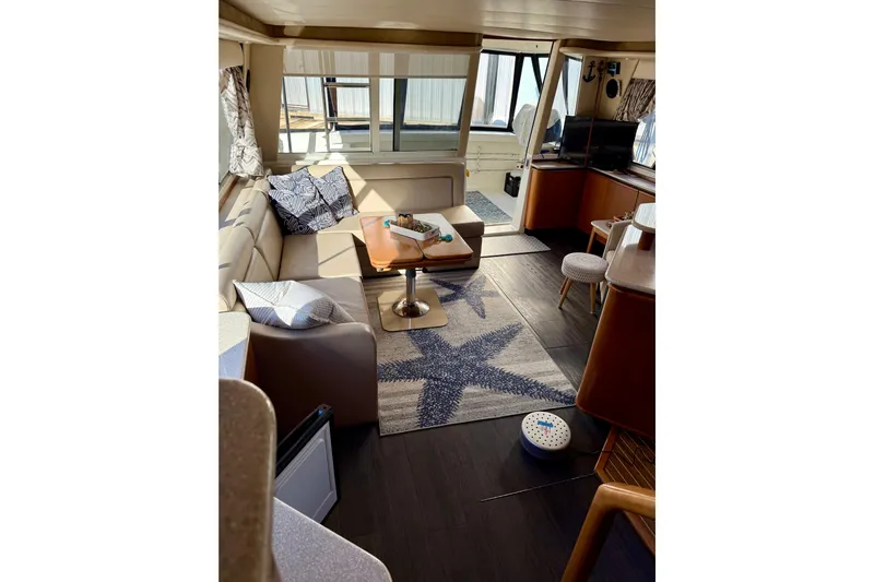 Trademarc Yacht Photos Pics Luxurious interior of 2004 Meridian 490 Pilothouse yacht with cozy seating and nautical decor.