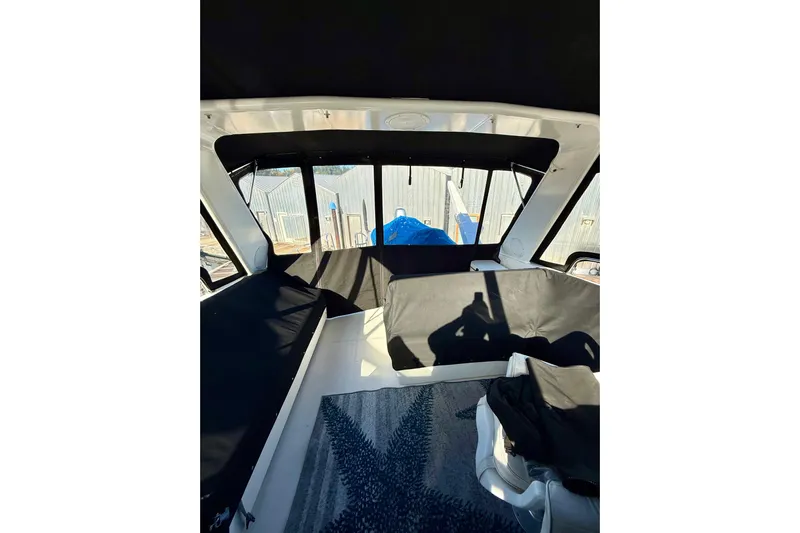 Trademarc Yacht Photos Pics Interior view of 2004 Meridian 490 Pilothouse with black seating and windows.