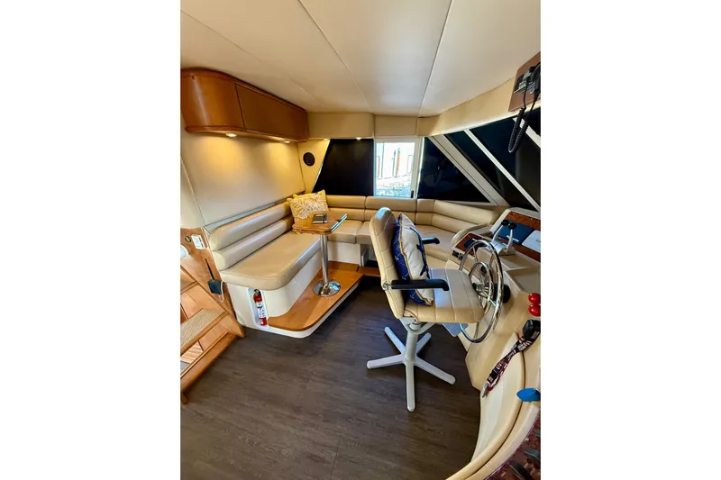 Trademarc Yacht Photos Pics Luxurious interior of 2004 Meridian 490 Pilothouse with helm and seating area.