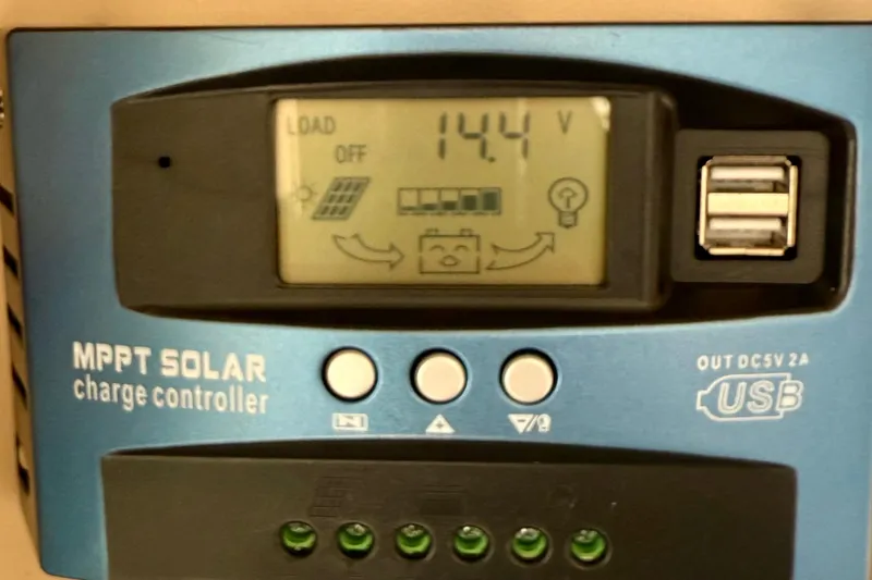 Trademarc Yacht Photos Pics MPPT solar charge controller display on 2004 Meridian 490 Pilothouse, showing 14.4V output.