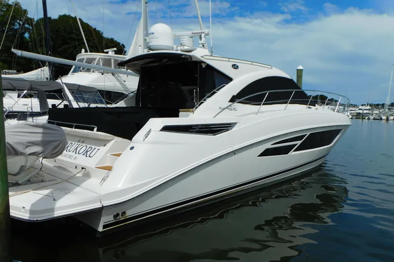  Yacht Photos Pics 2013 Sea Ray 510 Sundancer yacht docked in a marina under a blue sky.