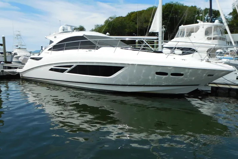  Yacht Photos Pics 2013 Sea Ray 510 Sundancer yacht docked at marina, reflecting on water.