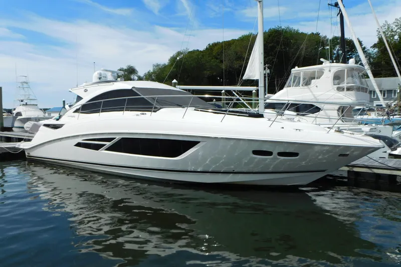  Yacht Photos Pics 2013 Sea Ray 510 Sundancer yacht docked at marina, reflecting on water.