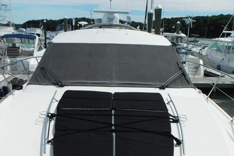  Yacht Photos Pics 2013 Sea Ray 510 Sundancer yacht docked at marina, featuring covered windshield and sunpad.