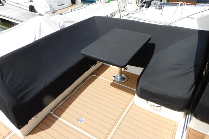  Yacht Photos Pics 2013 Sea Ray 510 Sundancer deck with black-covered seating and table.