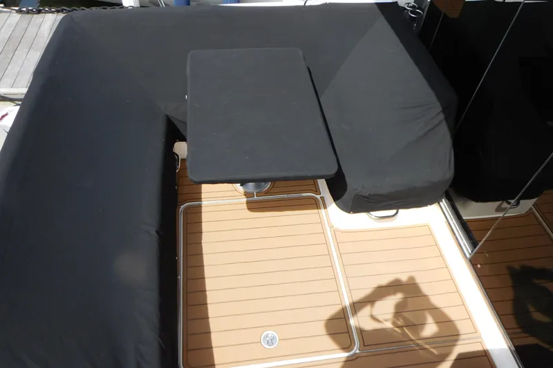  Yacht Photos Pics 2013 Sea Ray 510 Sundancer cockpit with black seating and table, teak flooring.