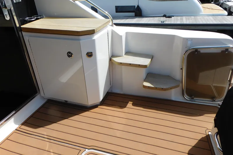  Yacht Photos Pics 2013 Sea Ray 510 Sundancer yacht deck with wooden steps and storage cabinet.