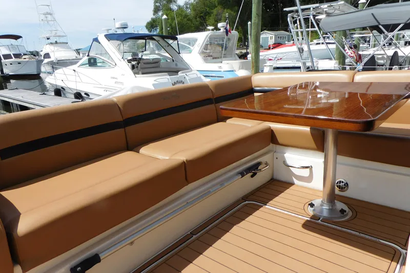  Yacht Photos Pics Luxurious seating area on a 2013 Sea Ray 510 Sundancer yacht, docked at a marina.