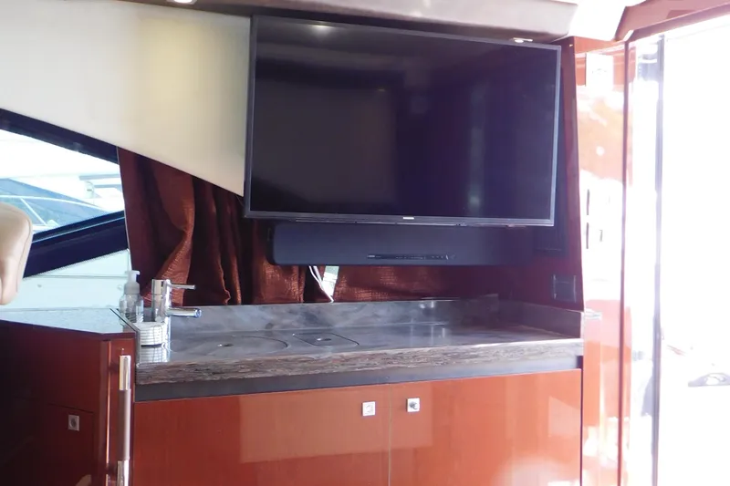  Yacht Photos Pics Luxurious interior of 2013 Sea Ray 510 Sundancer yacht with TV and kitchenette.