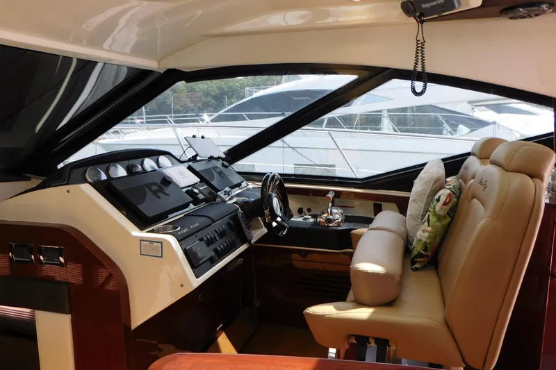  Yacht Photos Pics Interior cockpit of 2013 Sea Ray 510 Sundancer yacht with leather seating and modern controls.