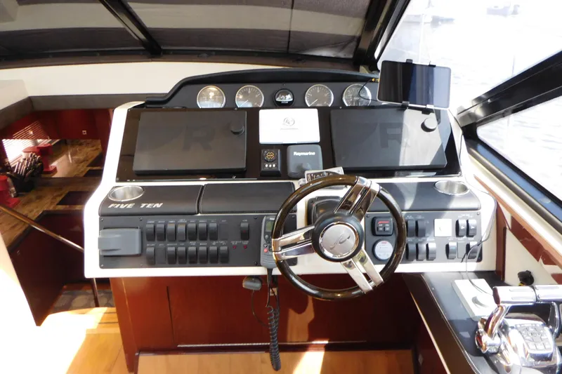  Yacht Photos Pics 2013 Sea Ray 510 Sundancer helm with modern controls and navigation equipment.