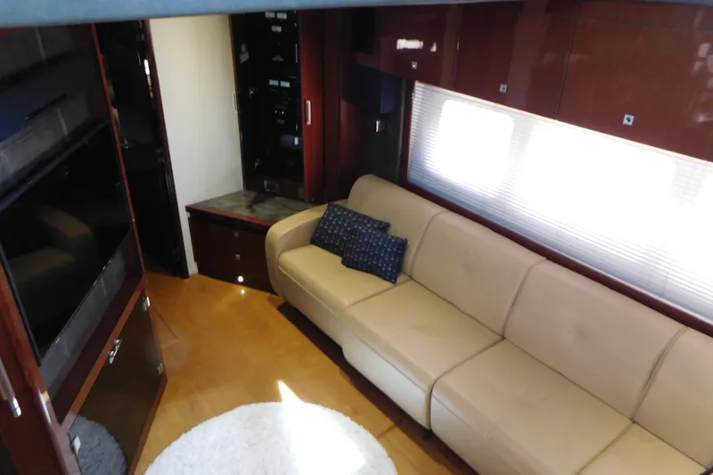  Yacht Photos Pics Luxurious interior of 2013 Sea Ray 510 Sundancer yacht with beige sofa and wooden cabinetry.