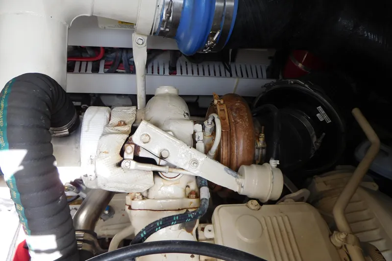  Yacht Photos Pics Engine compartment of a 2013 Sea Ray 510 Sundancer, showcasing mechanical components and hoses.