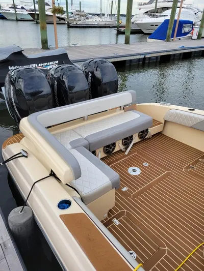  Yacht Photos Pics 2013 Statement 38 SUV Open boat with triple outboard engines docked at a marina.