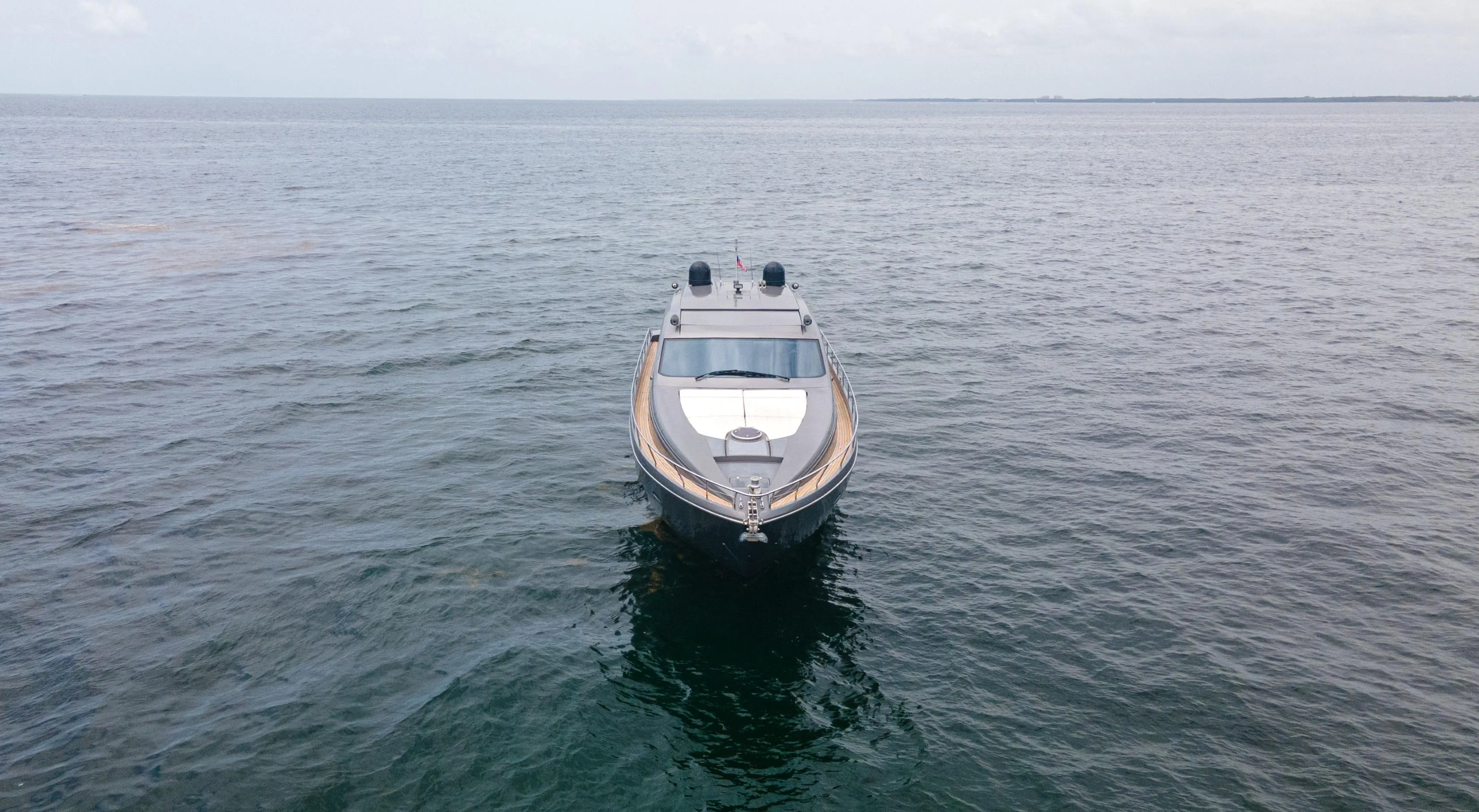 2009 Pershing 64 yacht on open water, viewed from the front.