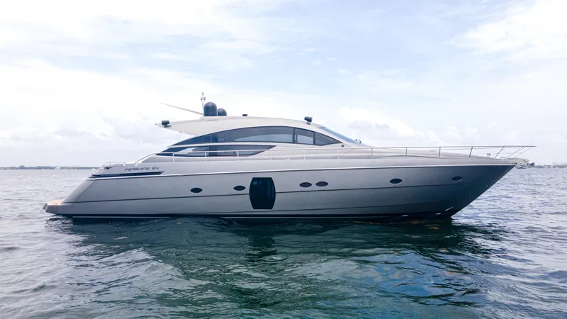 Wind Yacht Photos Pics 2009 Pershing 64 yacht on calm water under a cloudy sky.