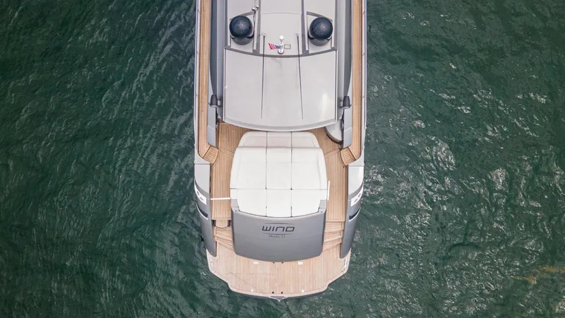 Wind Yacht Photos Pics Aerial view of 2009 Pershing 64 yacht on water, showcasing sleek design and deck layout.
